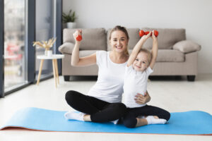 front view mother with daughter posing while holding weights